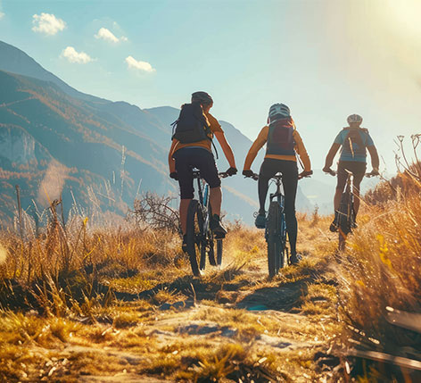 Group-of-friends-bicycling-up-a-mountain Group of frineds riding bicycles up a mountain path