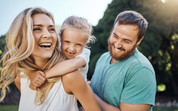 Happy-family-playing-outside Happy family smiling and playing outside