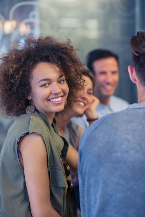 Woman in group of friends smiling at the camera