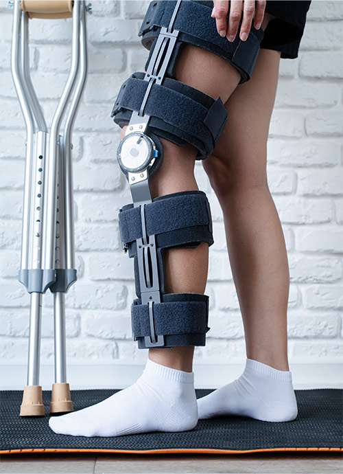 Woman wearing knee brace and crutches